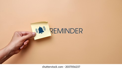 A sticker with drawings of a bell and the inscription: "Reminder". Reminder symbol