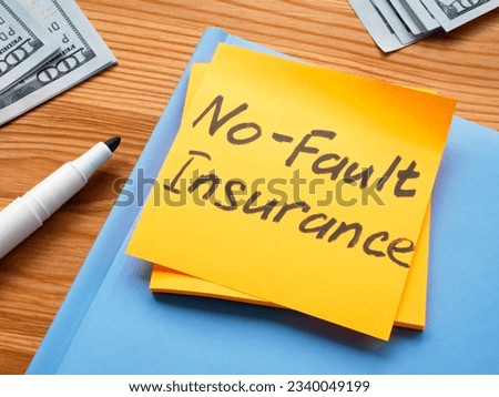 A Sticker with memo No fault insurance and notepad.