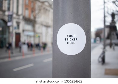 Sticker Mockup on a street lamp in a busy city street
