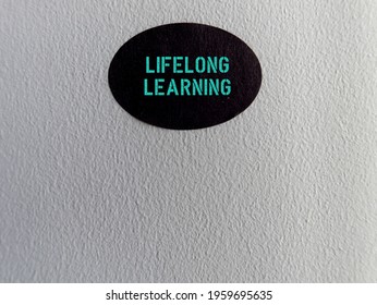 Sticker On Copy Space Wall Background With Text LIFELONG LEARNING,refers To Process Of Gaining Knowledge Learning New Skills Throughout Life- Continue Education For Personal Development Or Fulfillment