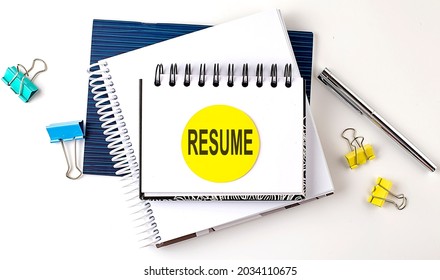 Sticker with RESUME text on notebooks on the white background