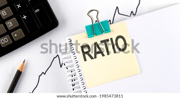 Stickers with pencils and notebook with text\
RATIO on the wooden\
background