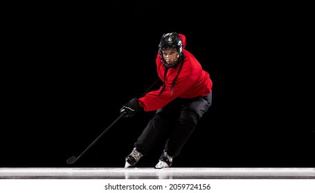 Stickhandling. Portrait of professional female hockey player training isolated over black background. Match, competition preparation. Concept of sport, action, movement, health. Copy space for ad - Powered by Shutterstock