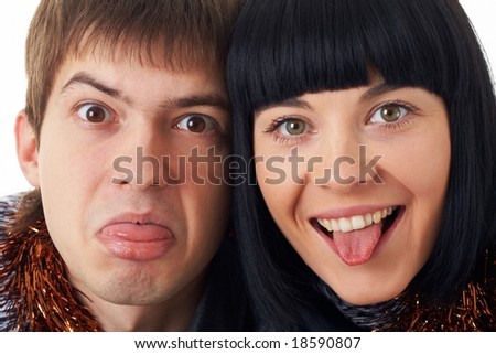 Sticking out tongue. Couple making funny silly face.