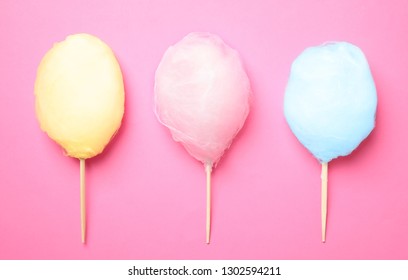 Sticks With Different Colorful Yummy Cotton Candy On Pink Background, Flat Lay