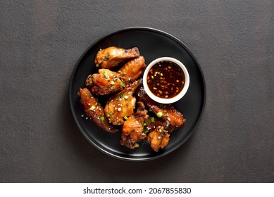 Sticky Honey-soy Chicken Wings On Plate Over Dark Stone Background. Top View, Flat Lay, Close Up