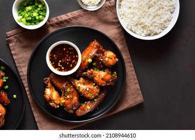 Sticky Honey-soy Chicken Wings On Plate Over Dark Stone Background. Top View, Flat Lay, Close Up