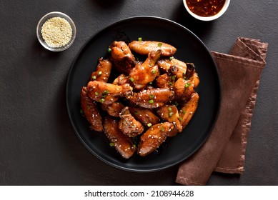 Sticky Honey-soy Chicken Wings On Plate Over Dark Stone Background. Top View, Flat Lay, Close Up