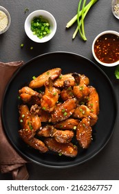 Sticky Honey-soy Chicken Wings On Plate Over Dark Stone Background. Top View, Flat Lay, Close Up