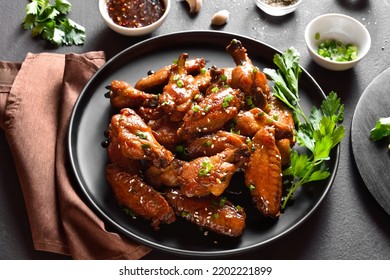 Sticky Honey-soy Chicken Wings On Plate Over Dark Stone Background. Close Up View