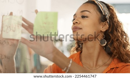 Sticky note, glass board and black woman planning startup success of clothes store, retail shop or fashion boutique. Small business owner working on strategy idea, sales target or goals manifestation