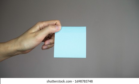 Sticky note with in a hand.