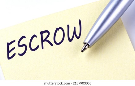 Sticky Note Message ESCROW With Pen On A White Background