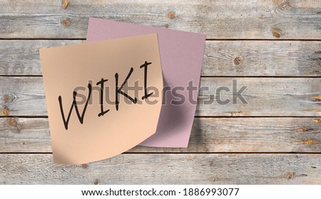 Sticky note on a wooden wall that says Wiki