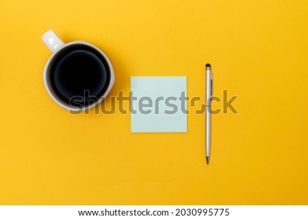 sticky note  and pen for important message on yellow isolated background. office supplies