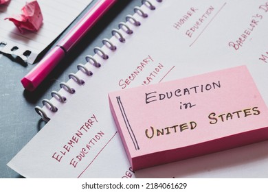 Sticky Note Pile With The Handwritten Note Education In United States On Desk.