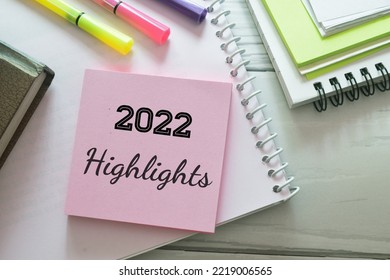 Sticky note pile with the inscription 2022 highlights on desk with stationery items. Major events, overview, looking back at 2022 year concept. - Shutterstock ID 2219006565