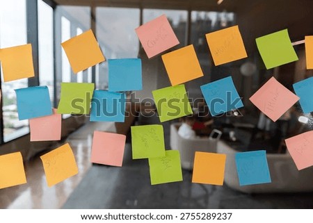 Sticky Note Post It Board Office. Business people meeting at office and use post it notes to share idea. Brainstorming concept. Sticky note on glass wall or blackboard. Set of colorful blank notes.