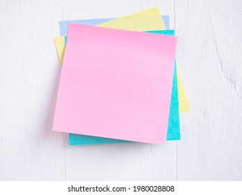 Sticky note ( Post-it) stack on a white wooden. Blank space for text and template for your message.