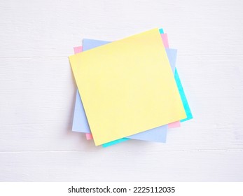 Sticky note ( Post-it) stack on a white wooden. Blank space for text and template for your message.