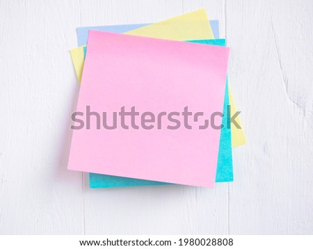 Sticky note ( Post-it) stack on a white wooden. Blank space for text and template for your message.