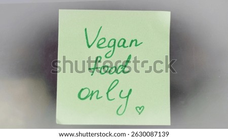 Sticky note reminders on kitchen fridge promoting healthy eating and wellness.
