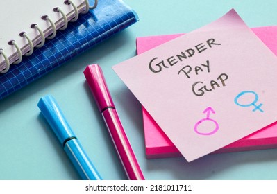 Sticky Note With The Text Gender Pay Gap And Symbols On Desk. Gender Inequality And Social Impact Concept.