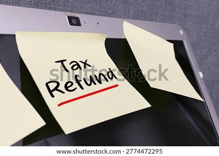 Sticky note with “Tax Refund” text representing financial return, reimbursement, and taxation concept.