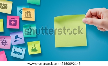 Sticky notes with school subjects icons, a student is holding a note with blank copy space