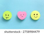 Sticky notes with smiley faces on blue background