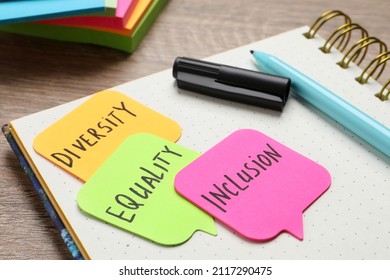 Sticky Notes With Words Diversity, Equality, Inclusion And Stationery On Wooden Table, Closeup