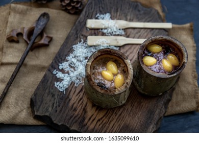 Sticky Rice Cooked with Coconut milk (Khao lam) or Glutinous rice roasted in bamboo joints on wooden, Thai dessert concept, Oblique view from the top.