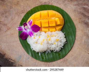 Sticky Rice Mango, Thai Dessert On Banana Leaf, Wood Texture, Top View