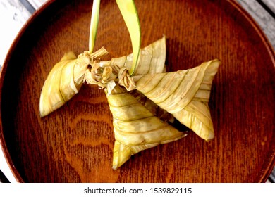 Sticky rice stir fried in coconut milk packed in palm leaves before steaming