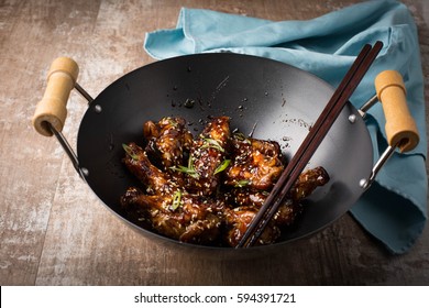 Sticky Sesame Chicken Wings In A Wok. 