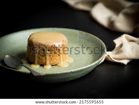 Sticky toffee pudding on a dark surface