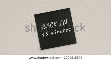 Sticky wall background featuring the Back in 15 minutes message used as a clear note or short notice, ideal as a clean backdrop for office, planning, and creative visual uses