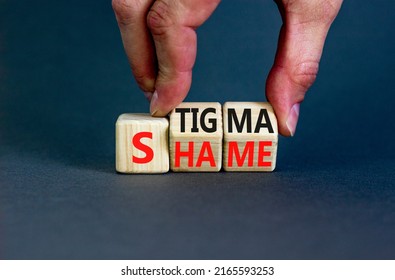 Stigma or shame symbol. Concept words Stigma or Shame on wooden cubes. Businessman hand. Beautiful grey table grey background. Business stigma or shame concept. Copy space.