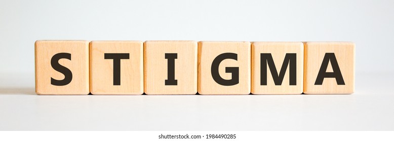 Stigma symbol. Wooden cubes with the word 'stigma'. Beautiful white background. Psychological, medical, business and stigma concept. Copy space.