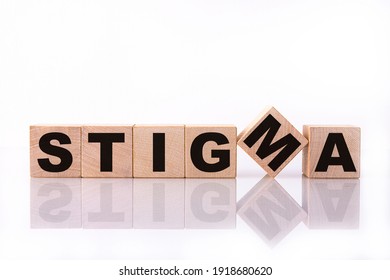 STIGMA word, text, written on wooden cubes, building blocks, over white background with reflection.