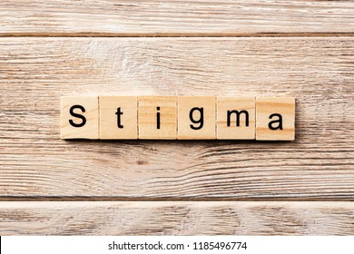 stigma word written on wood block. stigma text on table, concept.