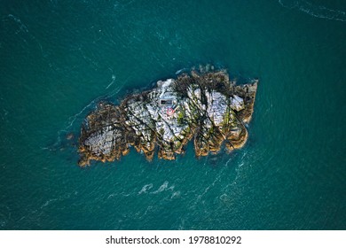 Still aerial top-down drone image of Muglins Lighthouse off shore of Irish sea near Dublin, Ireland 