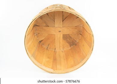 Still image of front view of turned wooden bushel over white background.