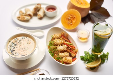 Still life from above on white tablecloth. Oriental dinner from soup with seeds, tempura shrimps and noodles with vegetables preparing for client. Three dishes lunch with mint tea ready for eating. - Powered by Shutterstock