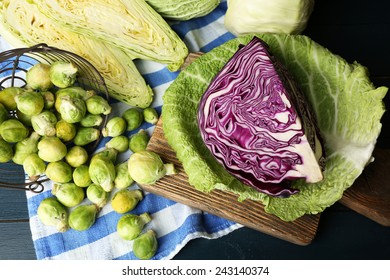 Still life with assortment cabbages on cutting board on color wooden background - Powered by Shutterstock