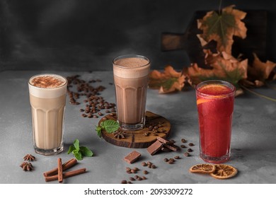 still life autumn composition with many transparent glasses of refreshing drink, raf coffee and espresso with frothed milk on a dark gray background. template for drink menu of cafe and restaurant