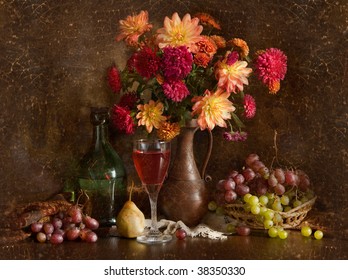 Still life and autumn flowers  grapes   wine