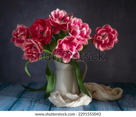 Still life with beautiful red-white tulips and a jug.