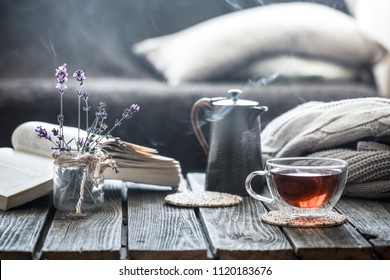 still life book and a cup of tea in the living room on a wooden table, the concept of coziness and interior - Powered by Shutterstock