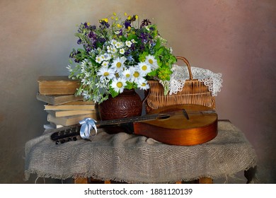 Still Life With A Bouquet Of Flowers, A Musical Instrument And Old Books .